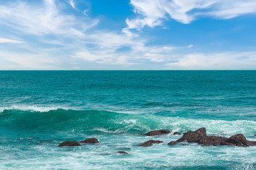 Big wave with sea foam and turquoise water.