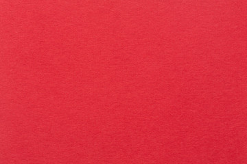 A red paper background with mottled texture.