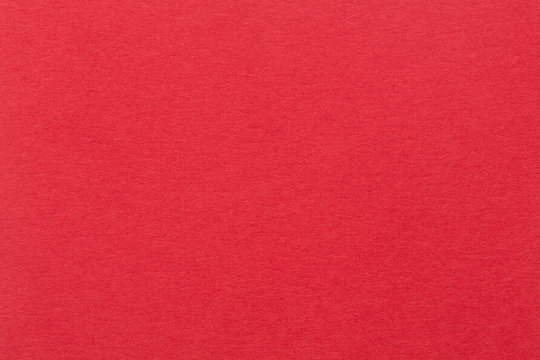 A Red Paper Background With Mottled Texture.