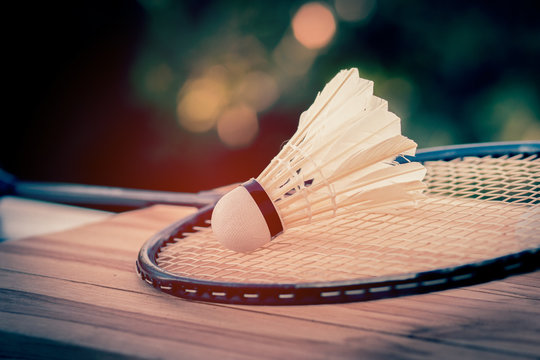 shuttlecocks and racket badminton with wood background, vintage