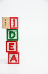 IDEA word wooden block arrange in vertical style on white background and selective focus