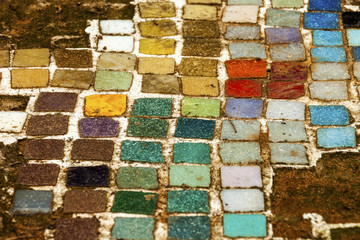 Colorful  Old Mosiac Tiles on Sandy Outdoor Garden Path