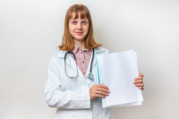 Female doctor showing blank medical clipboard