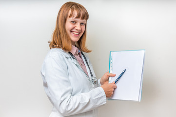 Female doctor showing blank medical clipboard