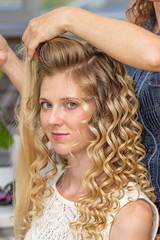 Fototapeta premium Hair stylist makes the bride before wedding