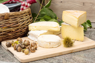 wooden tray with different french cheeses