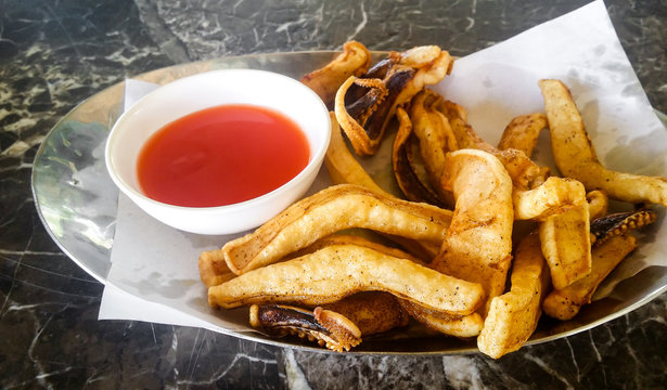 The Sun Dried Calamari Squid In Plate With Chili Sauce