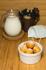 Cottage cheese fried balls in ceramic ramekin with milk
