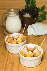 Cottage cheese fried balls in ceramic ramekin with milk