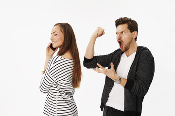 Guy shaking fists at woman on phone, studio
