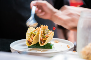 Hand cook Maxican food, plate with taco, tortilla chips and tomato dip
