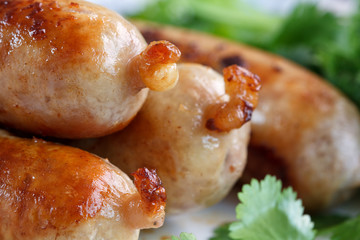 grilled sausages with green cilantro close up