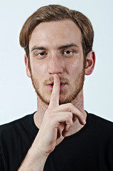 Be Quiet - Young Adult Male in Dark T-Shirt Gestures