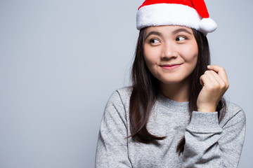 Happy woman wearing a santa hat on isolated background