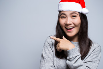 Happy woman wearing a santa hat on isolated background