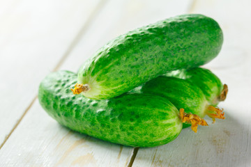  cucumbers on wooden background