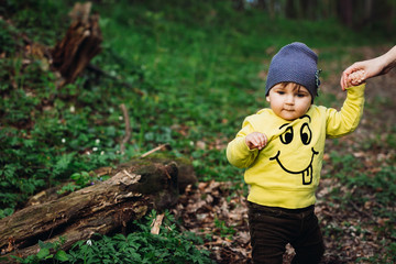 beautiful and cute baby walk in the forest