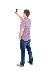 Back view of standing young men and using a mobile phone. - 125357524