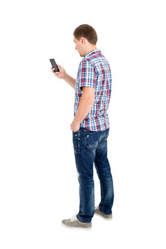 Back view of standing young men and using a mobile phone