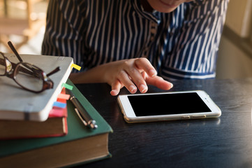 Woman using phone in cafe