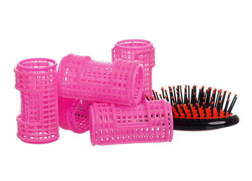 Plastic hairbrush with hair curlers, isolated on white background. Women tools for creating a beautiful hairstyle from ringlets.