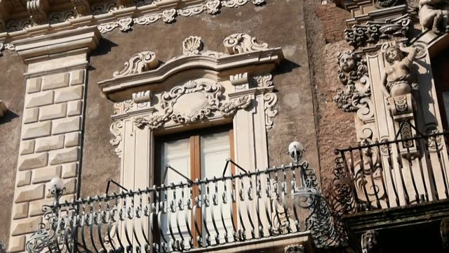 view of some typical baroque balconies in the city center of Catania in Sicily, Italy