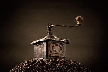 coffee grinder on top of hill of beans
