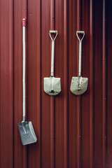 shovel on red wall background