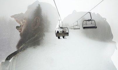 Closeup photo of stylish bearded traveler looking into the distance. Double exposure, winter landscape with ski lifts for skiers and snowboarders.