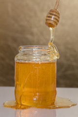 Jar of honey with honey dipper