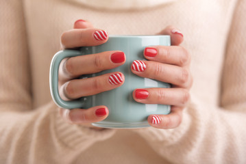 Women's hands holding a cup of drink. © Tanya Rozhnovskaya