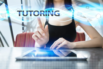 Woman is using tablet pc, pressing on virtual screen and selecting tutoring
