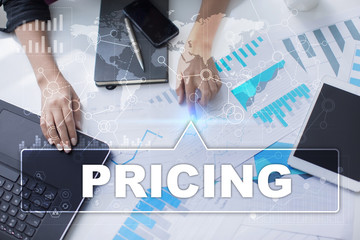 Woman is working with documents, tablet pc and notebook and selecting pricing.