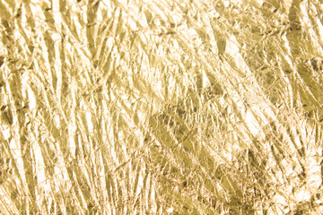 Gold wrinkled paper texture abstract background