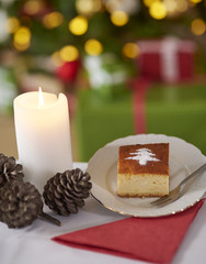 Sweet cake and Christmas tree in the background