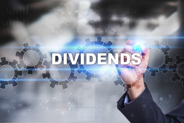 Businessman is drawing on virtual screen. dividends concept.