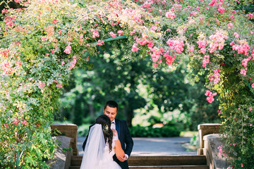 The bride and groom in a lush garden, relationships, family, wedding