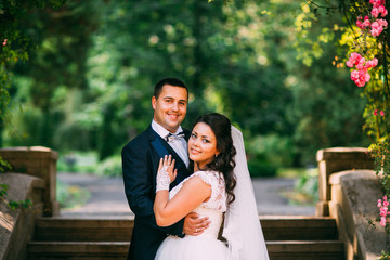 The bride and groom in a lush garden, relationships, family, wedding