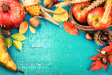 Autumn frame with pomegranate, apple and fall leaves