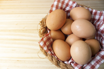eggs in a basket wooden background