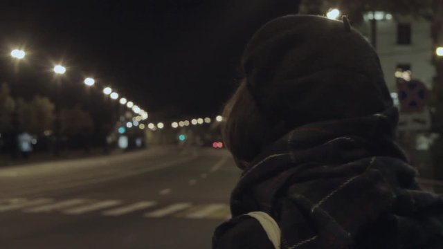 Young woman waiting taxi night city street hyperlapse cold tone shot