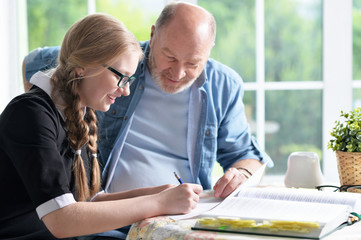 grandfather and  granddaughter doing homework