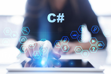 Woman is using tablet pc, pressing on virtual screen and selecting c#