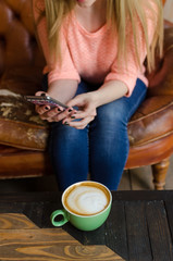 Young woman with coffee and phone