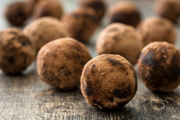 Homemade chocolate truffles on wooden table

