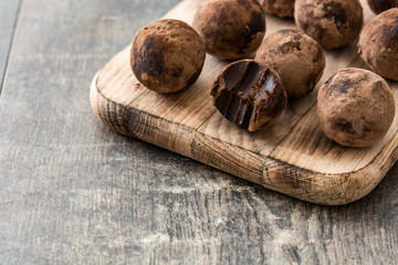 Homemade chocolate truffles on wooden table

