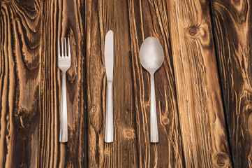 evenly folded cutlery on a wooden table