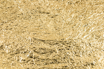 Gold wrinkled paper texture abstract background