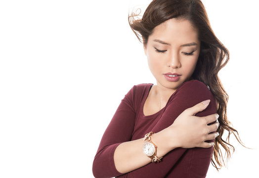 beautiful young asian woman with long hair posing in casual clothes and wearing a wrist watch on isolated background