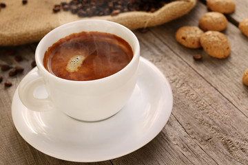 Fototapeta na wymiar Cup of coffee on wooden surface 